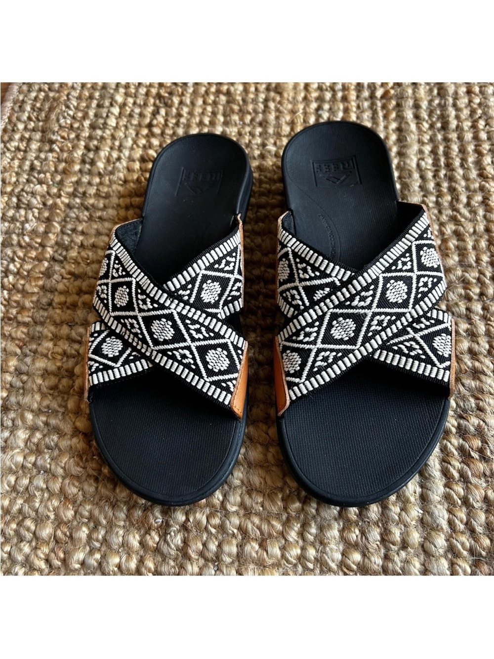 Reef Black Slide Sandals with Black & White Patterned Straps and Leather Accent